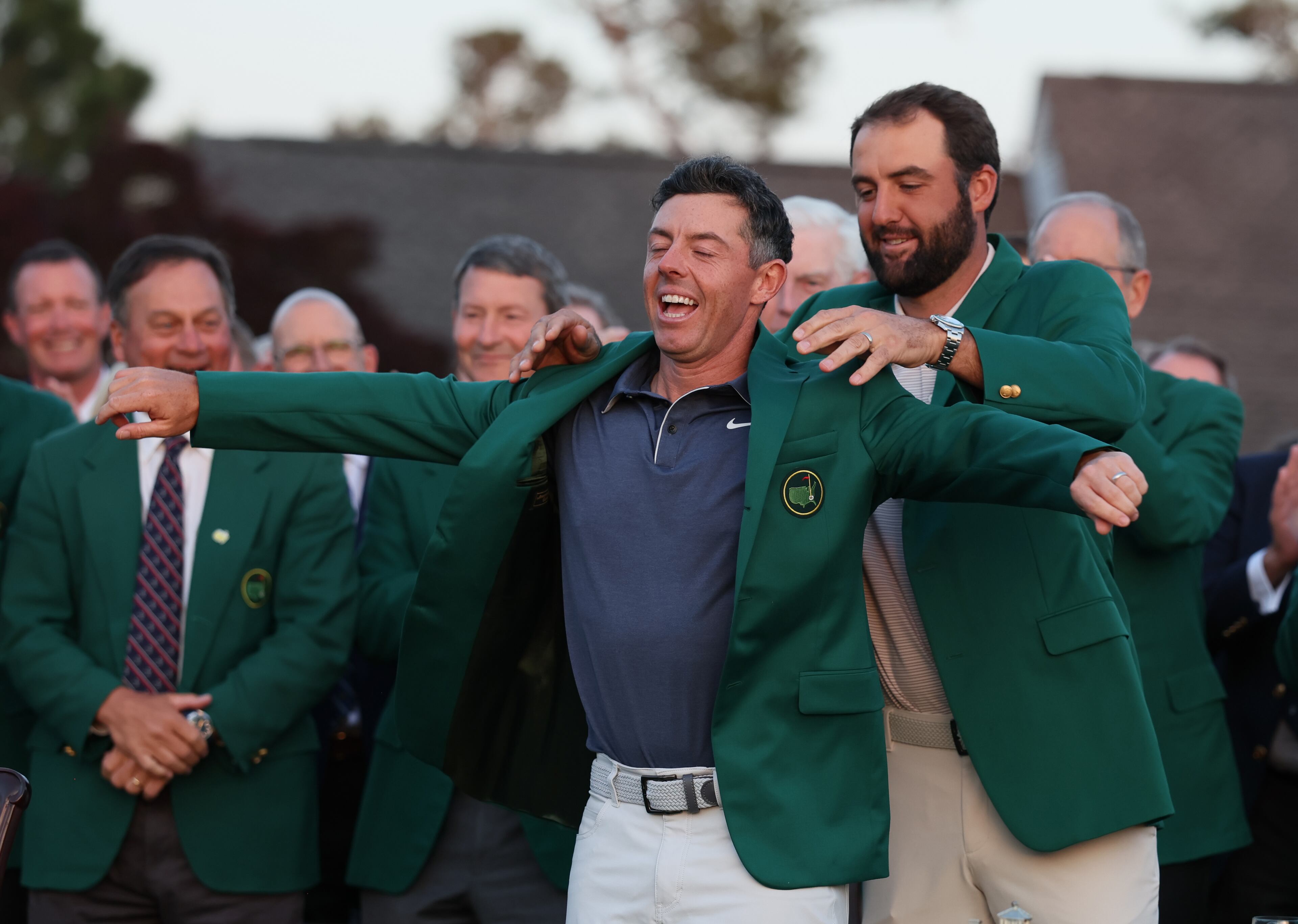 Scottie Scheffler, 2024 Masters champion, places green jacket on 2025 winner Rory McIlroy at Augusta National Golf Club, Sunday, April 13, 2025, in Augusta, Ga. (Jason Getz / AJC)