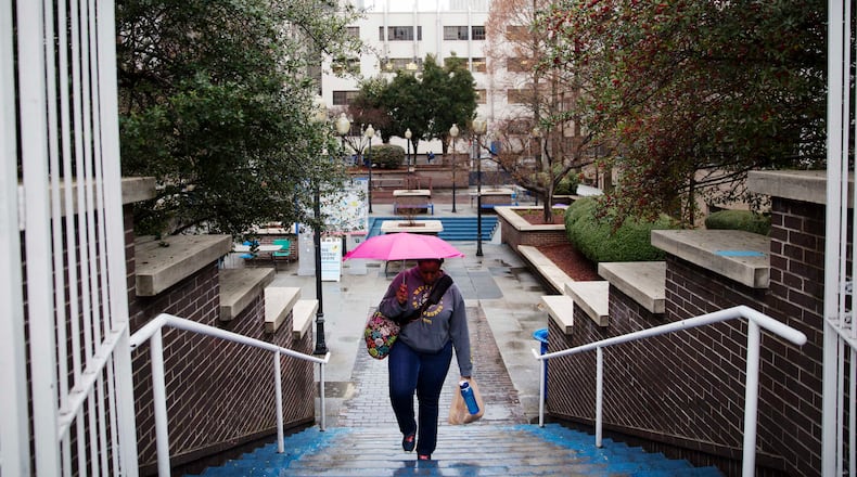 A pedestrian climbs a stairwell to the library at the Georgia State University campus Monday, Feb. 22, 2016, in Atlanta. Anyone licensed to carry a gun in Georgia could carry concealed handguns on public college campuses under a bill passed Monday by the Georgia House. Several recent armed robberies at the library on the Georgia State University campus renewed backers' argument for carrying on campuses. (AP Photo/David Goldman)