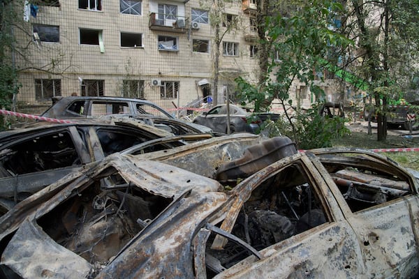 Damaged private cars are seen on the site of Russia's deadly missile attack on Tuesday, in Kyiv, Ukraine, Wednesday, June 18, 2025. (AP Photo/Efrem Lukatsky)