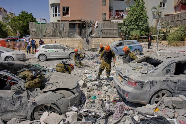 Israeli soldiers work amid the rubble of residential buildings destroyed by an Iranian missile strike that killed several people, in Beersheba, Israel, on Tuesday, June 24, 2025. (AP Photo/Bernat Armangue)