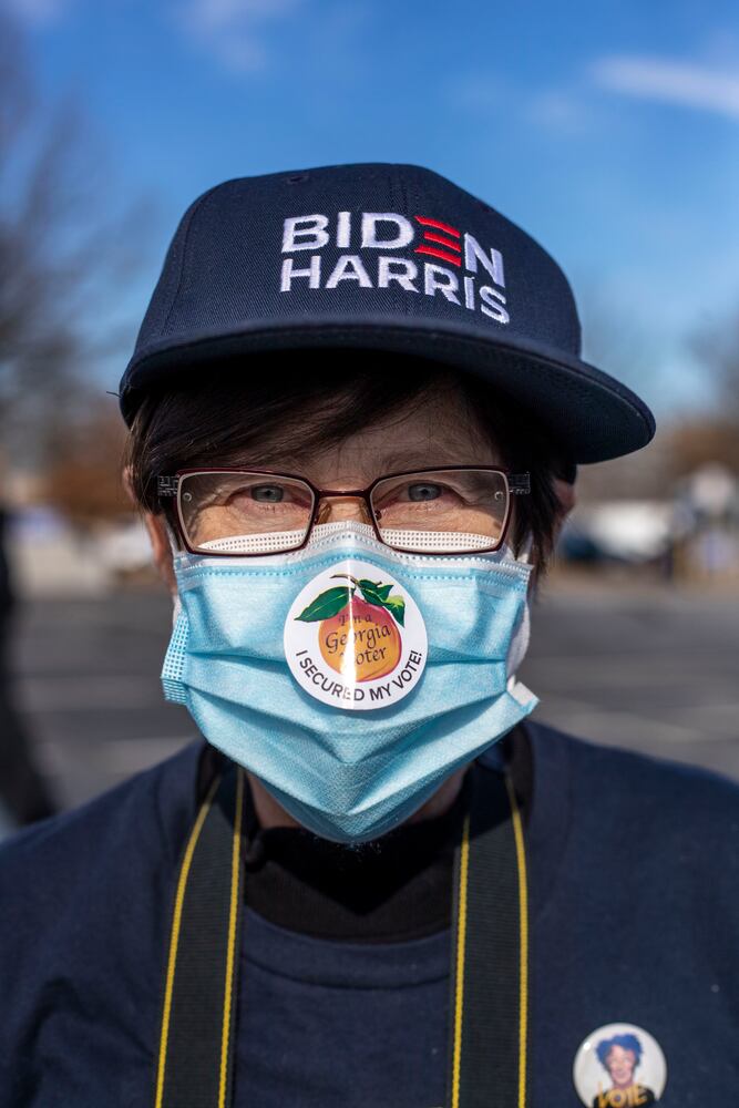 01/04/2021 — Atlanta, Georgia — Dr. Melanie Thompson wears a Georgia voter sticker on her face mask during a Georgia Democrat U.S. Senate campaign rally in Atlanta’s Peoplestown neighborhood, Monday, January 4, 2021.(Alyssa Pointer / Alyssa.Pointer@ajc.com)