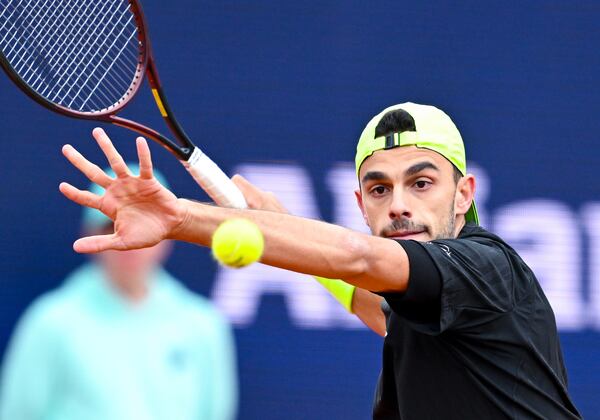 Argentina's Francisco Cerundolo returns the ball to Belgium's David Goffin during the men's singles quarterfinal match at the Munich tennis tournament, in Munich, Germany, Friday April 18, 2025. (Sven Hoppe/dpa via AP)