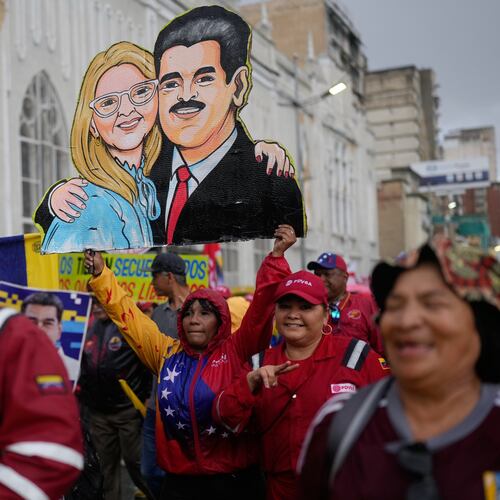 Government supporters carry a cutout of former President Nicolás Maduro and his wife Cilia Flores during a rally marking the anniversary of the 1958 coup that overthrew Venezuelan dictator Marcos Pérez Jiménez, in Caracas, Venezuela, Friday, Jan. 23, 2026. (AP Photo/Ariana Cubillos)