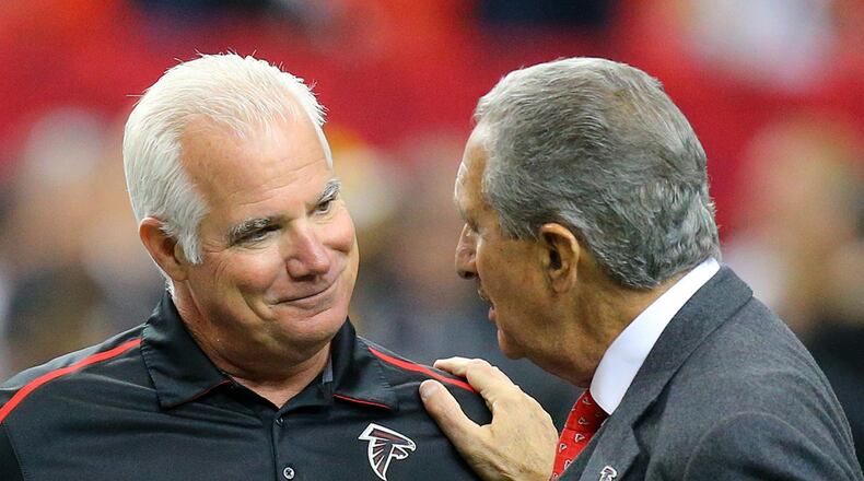 Former Falcons head coach Mike Smith and team owner Arthur Blank greet each other before playing the Steelers in a football on Sunday, Dec. 14, 2014, in Atlanta. CURTIS COMPTON / CCOMPTON@AJC.COM (Curtis Compton, AJC)