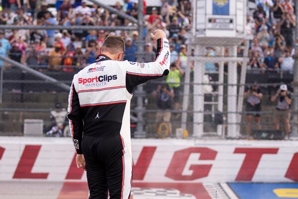Denny Hamlin celebrates after winning a NASCAR Cup Series auto race at Darlington Raceway, Sunday, April 6, 2025, in Darlington, S.C. (AP Photo/Scott Kinser)