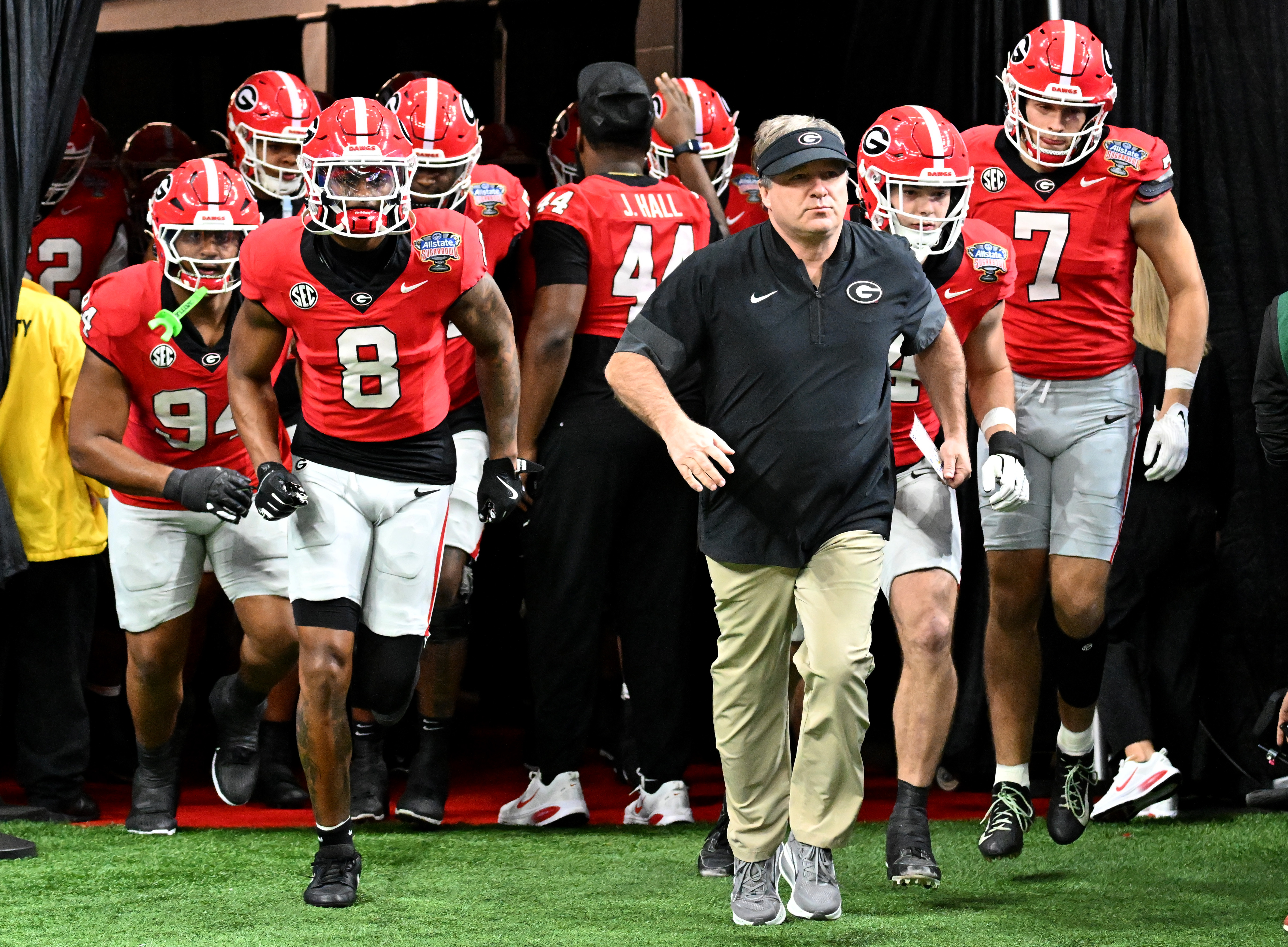 Georgia head coach Kirby Smart and players run onto the field for warm up before the Sugar Bowl against Ole Miss at the Caesars Superdome, Thursday, Jan. 1, 2026, in New Orleans. (Hyosub Shin/AJC)