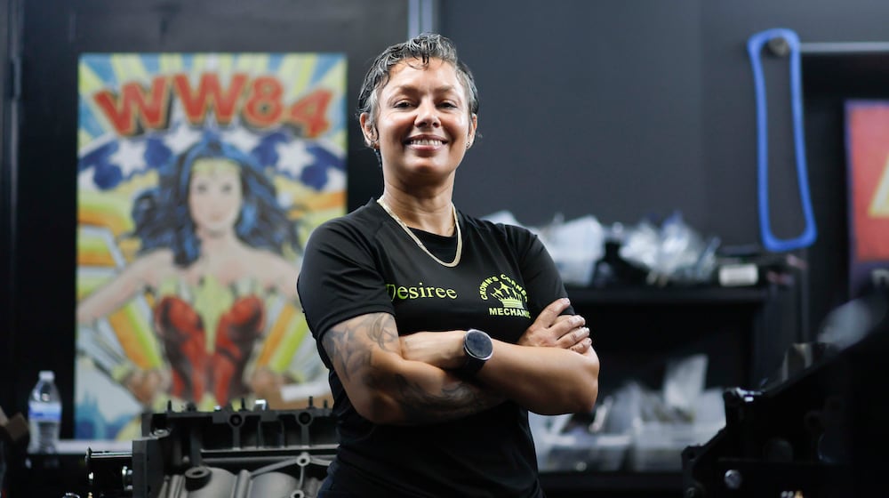 Desiree White, owner of Crown’s Corner Mechanics, stands in the engine room where she has five machines working simultaneously on Thursday, June 4, 2026. The shop offers general mechanic services, but specializes in building vintage car engines. (Miguel Martinez/AJC)