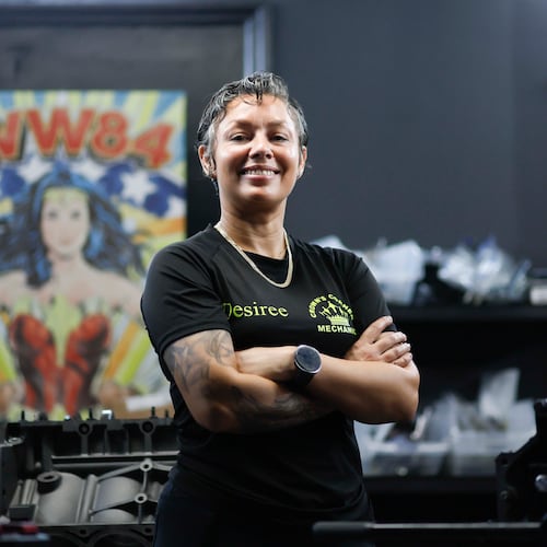 Desiree White, owner of Crown’s Corner Mechanics, stands in the engine room where she has five machines working simultaneously on Thursday, June 4, 2026. The shop offers general mechanic services, but specializes in building vintage car engines. (Miguel Martinez/AJC)
