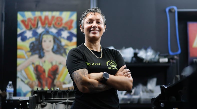 Desiree White, owner of Crown’s Corner Mechanics, stands in the engine room where she has five machines working simultaneously on Thursday, June 4, 2026. The shop offers general mechanic services, but specializes in building vintage car engines. (Miguel Martinez/AJC)