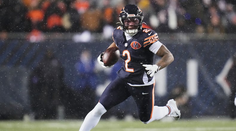 FILE - Chicago Bears wide receiver DJ Moore runs after making a catch against the Los Angeles Rams during the first half of an NFL football divisional playoff game, Jan. 18, 2026, in Chicago. (AP Photo/Jeff Roberson, File)