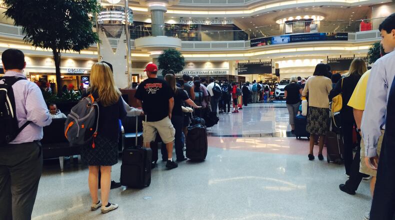 Lines at Hartsfield-Jackson International Airport Tuesday morning stretched from the main security checkpoint to the atrium. KELLY YAMANOUCHI / KELLY.YAMANOUCHI@AJC.COM