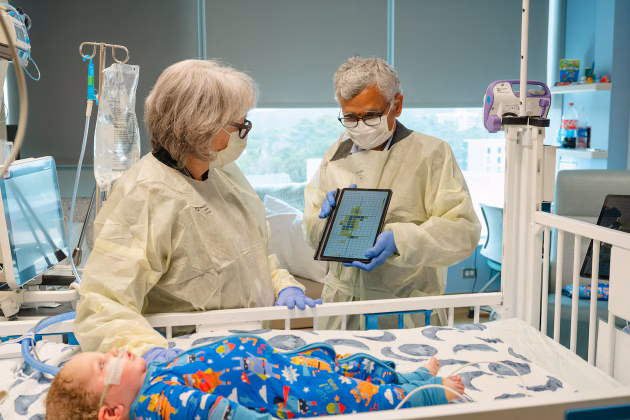 Dr. Jana Stockwell (left) and researcher Sundaresan Jayaraman discuss pilot testing a new pressure injury prevention system, using "smart" bedsheets. (Courtesy of Georgia Tech)