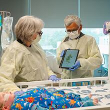 Dr. Jana Stockwell (left) and researcher Sundaresan Jayaraman discuss pilot testing a new pressure injury prevention system, using "smart" bedsheets. (Courtesy of Georgia Tech)