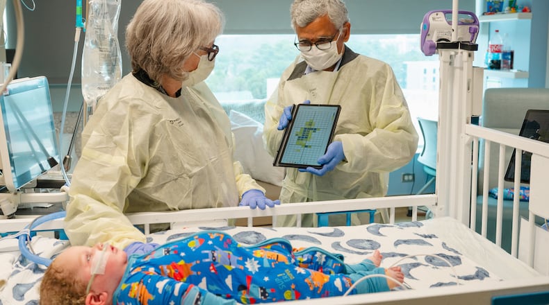 Dr. Jana Stockwell (left) and researcher Sundaresan Jayaraman discuss pilot testing a new pressure injury prevention system, using "smart" bedsheets. (Courtesy of Georgia Tech)