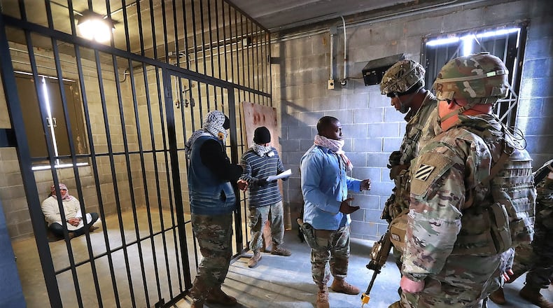 Sgt. Clayton Peck, right, and Sgt. Keenan Griffin, both members of the Georgia National Guard’s 48th Brigade, participate in a role-playing training event at Fort Stewart ahead of their upcoming deployment to Afghanistan. Curtis Compton/ccompton@ajc.com