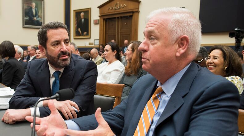 Kevin Riley, editor of The Atlanta Journal-Constitution, right, talks with David Pitofsky, the general counsel of News Corp, during their appearance Tuesday before a House Judiciary Antitrust subcommittee hearing. (AP Photo/Cliff Owen)