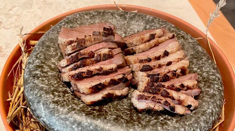 The hay-smoked miso duck breast at Brush Sushi is served on stone under a glass cloche filled with hay smoke. Angela Hansberger for The Atlanta Journal-Constitution