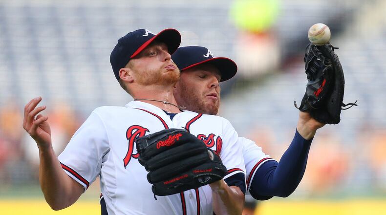***** VISUAL LEDE ***** 060815 Atlanta: Braves first baseman Freddie Freeman (right), who called the ball, can’t hold on to a foul ball by Padres Justin Upton as pitcher Shelby Miller collides with him during the first inning of a baseball game on Monday, June 8, 2015, in Atlanta. Curtis Compton / ccompton@ajc.com