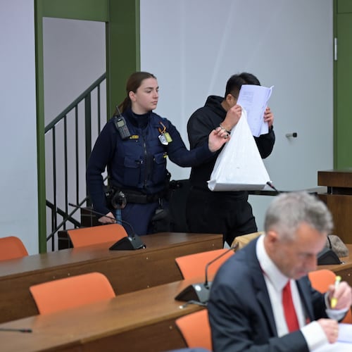 The defendant covers his face as he arrives for a trial against a network of mostly Chinese men, organized in chat groups to advise one another on how to drug and rape mostly Chinese women, in Munich, Germany, Feb. 2, 2026. (Malin Wunderlich/dpa via AP)