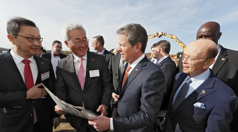March 19, 2019 - Atlanta - SK Group Executive Vice Chairman Jaewon Chey, left, SK Innovation President and CEO Jun Kim, Gov. Brian Kemp, and U.S. Secretary of Commerce Wilbur Ross look over a full page ad in Monday’s Atlanta Journal-Constitution promoting SK Innovation’s planned battery plant in Jackson County. The South Korean conglomerate broke ground Tuesday on a new nearly $1.7 billion battery plant in Jackson County, one of the largest single economic development projects in the state’s history and one that will bring a significant foreign investment — and 2,000 jobs. Bob Andres / bandres@ajc.com