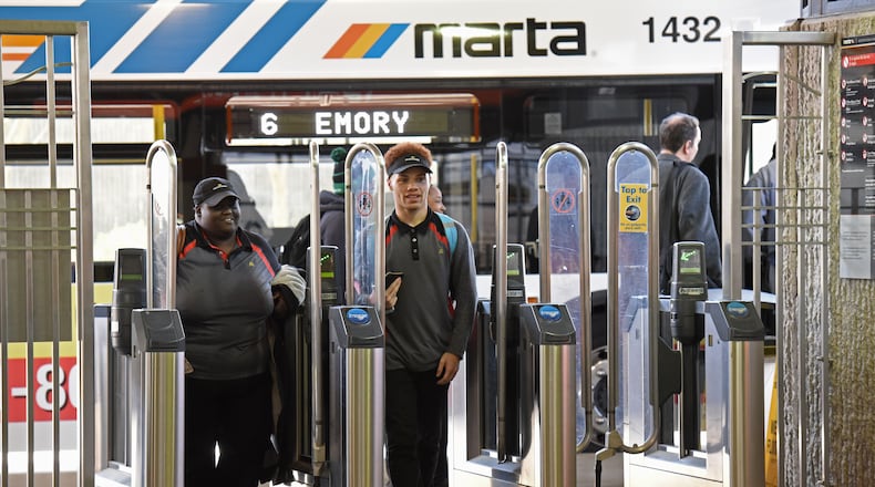 Commuters purchase rides at Breeze Card stations at North Springs MARTA station on Monday. The collapse of a section of I-85 has increased MARTA's ridership as more commuters turn to the transit system to get to work. David Barnes, David.Barnes@ajc.com