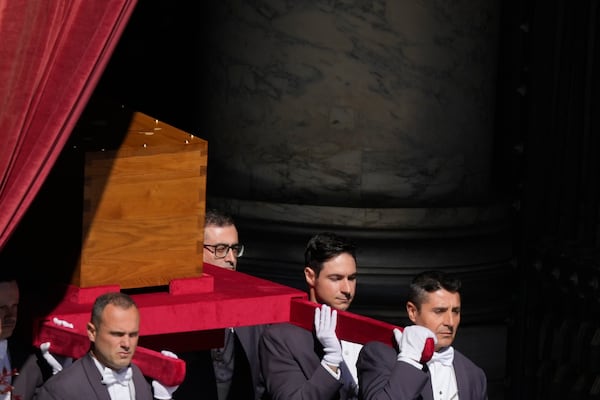 The coffin of Pope Francis is carried out of St Peter's Basilica during his funeral, in St. Peter's Square at the Vatican, Saturday, April 26, 2025. (AP Photo/Gregorio Borgia)