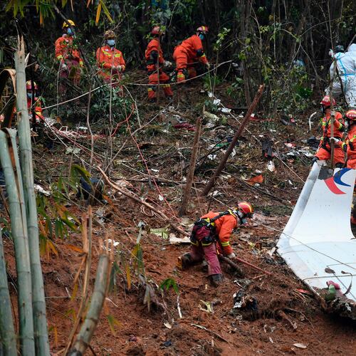 FILE - In this photo released by Xinhua News Agency, search and rescue workers search through debris at the China Eastern flight crash site in Tengxian County in southern China's Guangxi Zhuang Autonomous Region on March 24, 2022. (Lu Boan/Xinhua via AP, File)