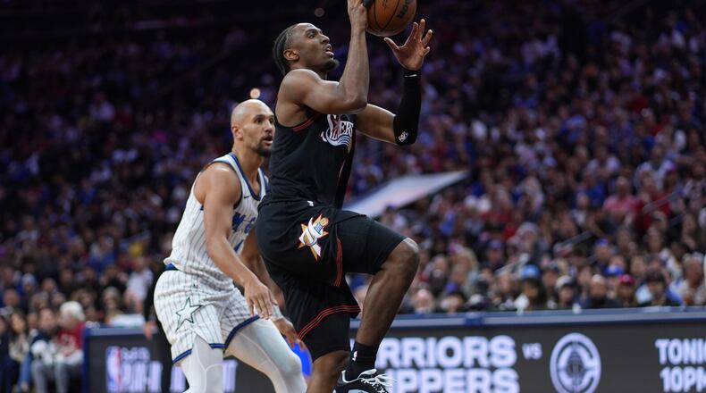 Philadelphia 76ers' Tyrese Maxey, right, goes up for a shot against Orlando Magic's Jalen Suggs during the second half of an NBA play-in tournament basketball game Wednesday, April 15, 2026, in Philadelphia. (AP Photo/Matt Slocum)