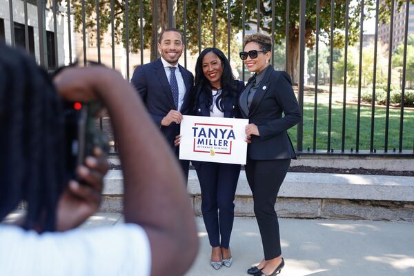 State Rep. Tanya Miller, D-Atlanta, (center) takes a photo with colleagues Rep. Omari Crawford, D-Decatur, (left) and Rep. Inga Willis, D-Atlanta, (right)  shortly after announcing her candidacy for attorney general outside of the Georgia State Capitol on Monday, Aug. 25, 2025. (Natrice Miller/AJC)