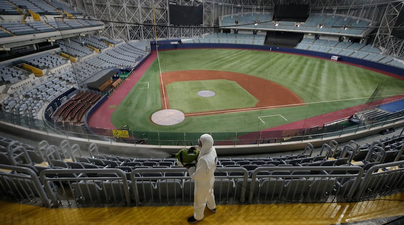 A worker wearing protective gears disinfects as a precaution against the new coronavirus at Gocheok Sky Dome in Seoul, South Korea.