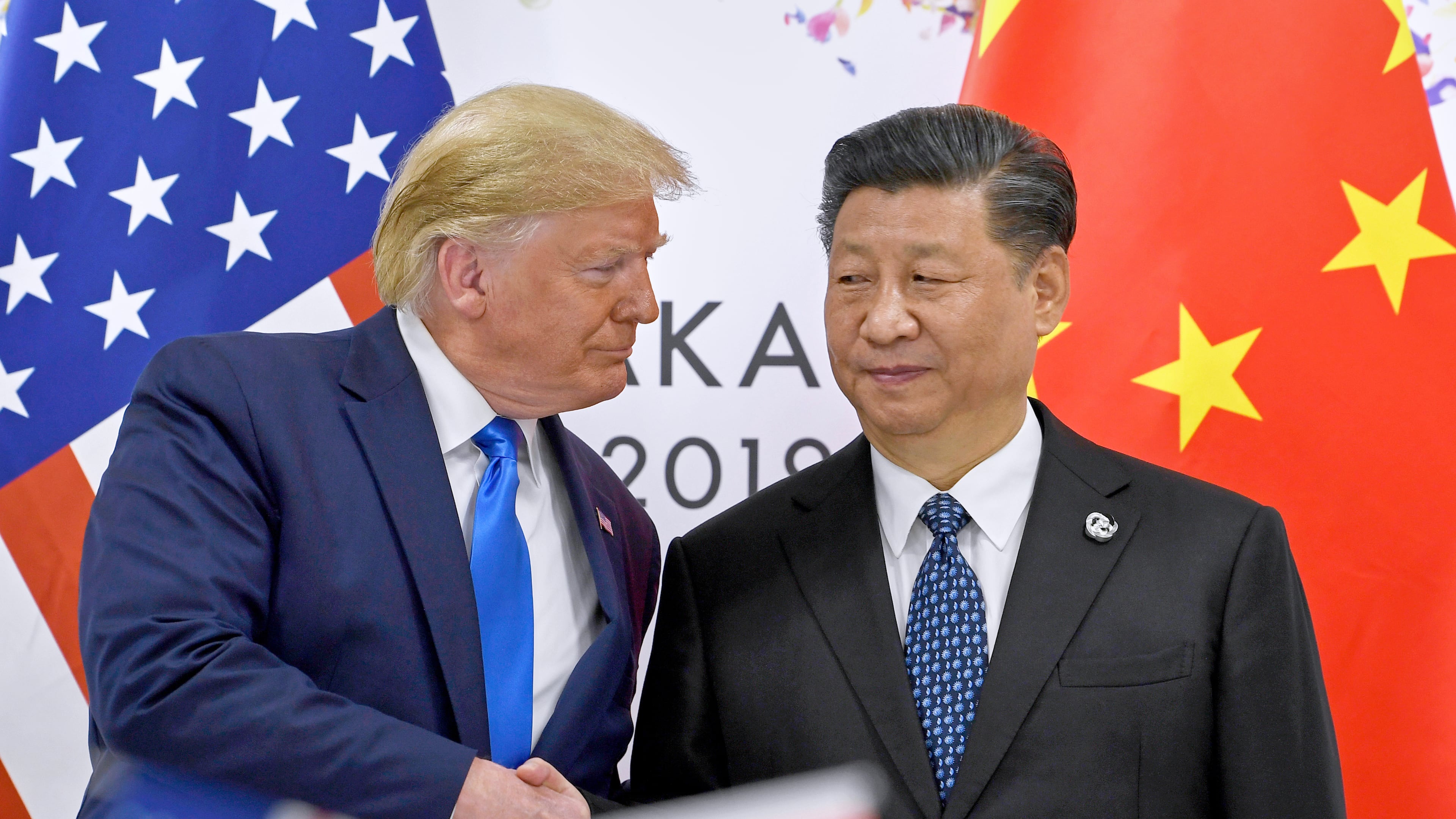 FILE - U.S. President Donald Trump, left, shakes hands with Chinese President Xi Jinping during a meeting on the sidelines of the G-20 summit in Osaka, western Japan, June 29, 2019. (AP Photo/Susan Walsh, File)