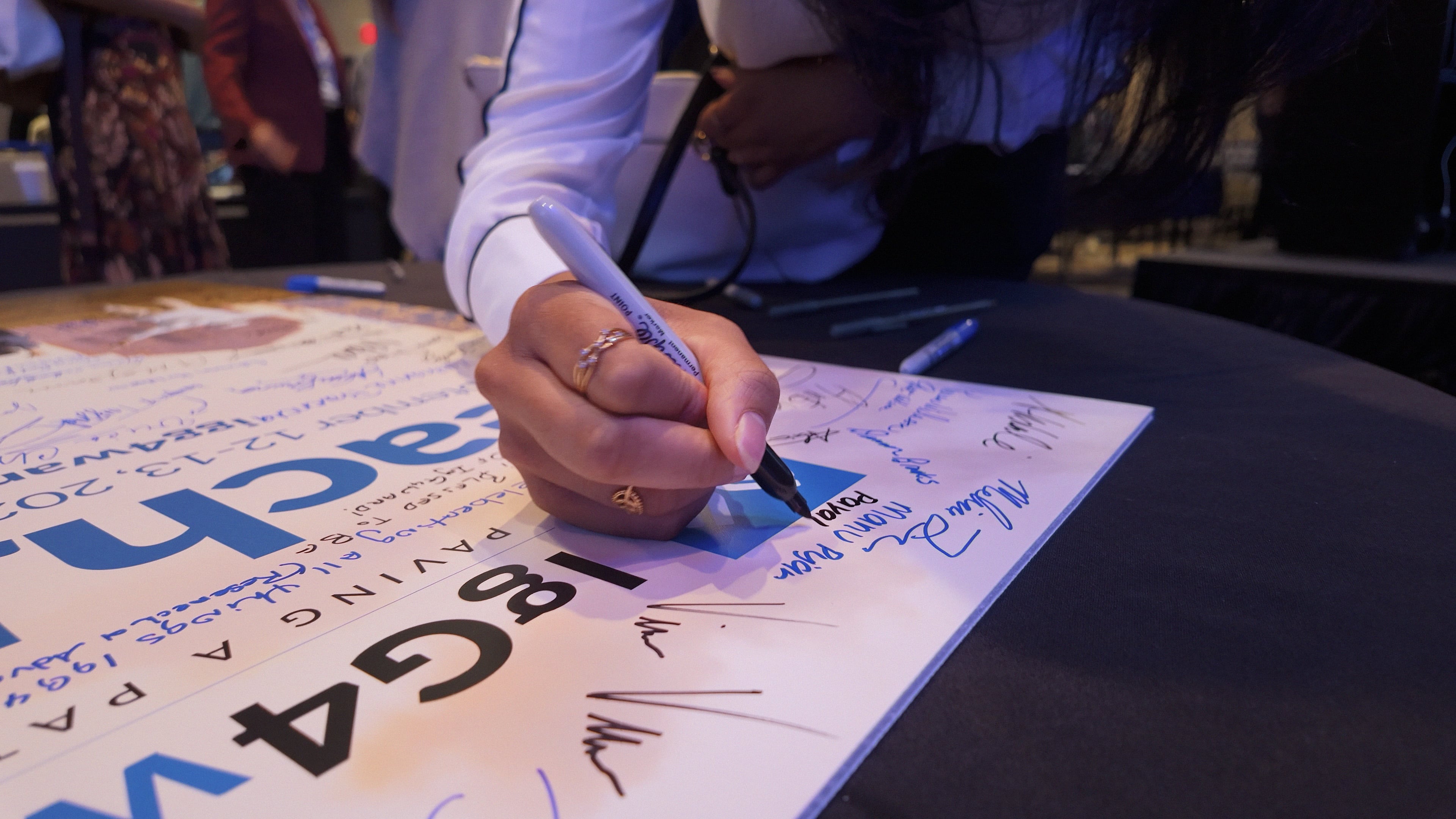 Doctors and patients sign a board at the annual PeachJAM, the nation’s only event dedicated to spotlighting Immunoglobulin G4-related disease. (Courtesy of PeachJAM)