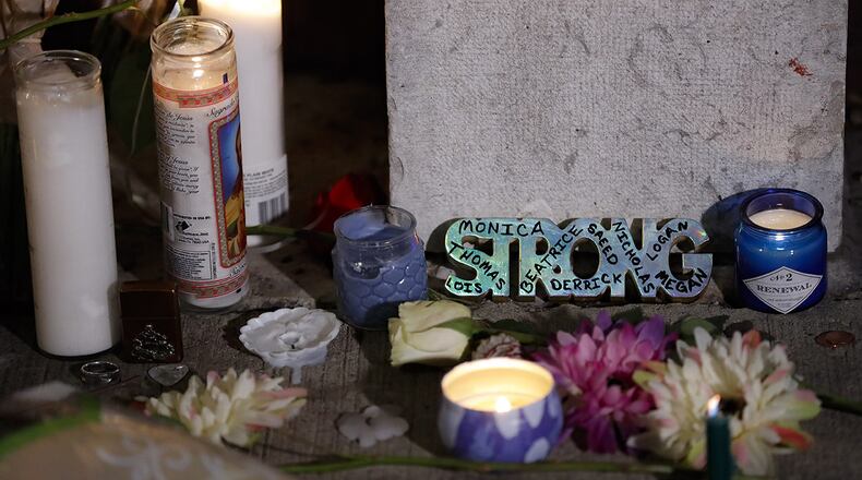 A makeshift memorial is setup outside Ned Peppers bar following a vigil at the scene of a mass shooting, Sunday, Aug. 4, 2019, in Dayton, Ohio.