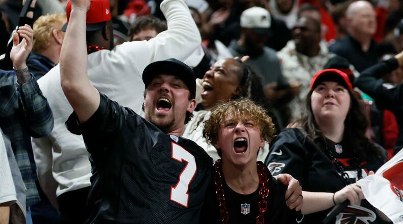 Falcons fans react after Falcons running back Bijan Robinson scores a touchdown during the first half of an NFL football game against the Los Angeles Rams at Mercedes-Benz Stadium in Atlanta on Monday, Dec. 29, 2025. (Miguel Martinez/AJC)