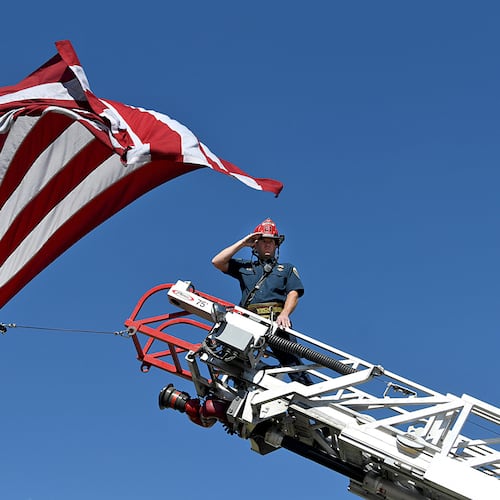 A captain with the Clifton Fire Protection District salutes the passing procession carrying the bodies of three firefighters killed while fighting the Snyder Fire in Grand Junction, Colo. Sunday, June 28, 2026. (Gretel Daugherty via AP)