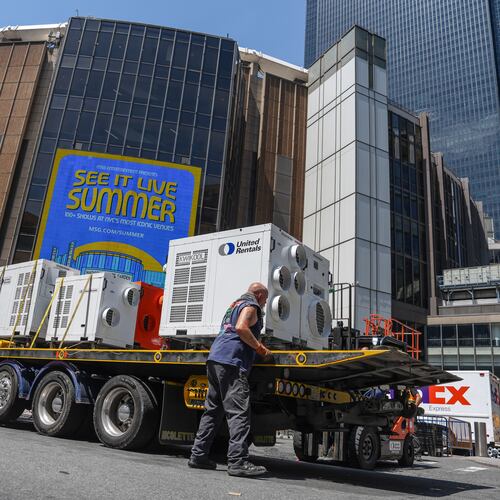 A worker unloads portable air-conditioning units outside of Madison Square Garden ahead of a reported wedding between singer Taylor Swift and National Football League player Travis Kelce on Thursday, July 2, 2026, in New York. (AP Photo/Ryan Murphy)