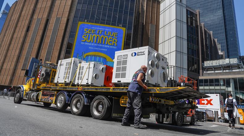 A worker unloads portable air-conditioning units outside of Madison Square Garden ahead of a reported wedding between singer Taylor Swift and National Football League player Travis Kelce on Thursday, July 2, 2026, in New York. (AP Photo/Ryan Murphy)