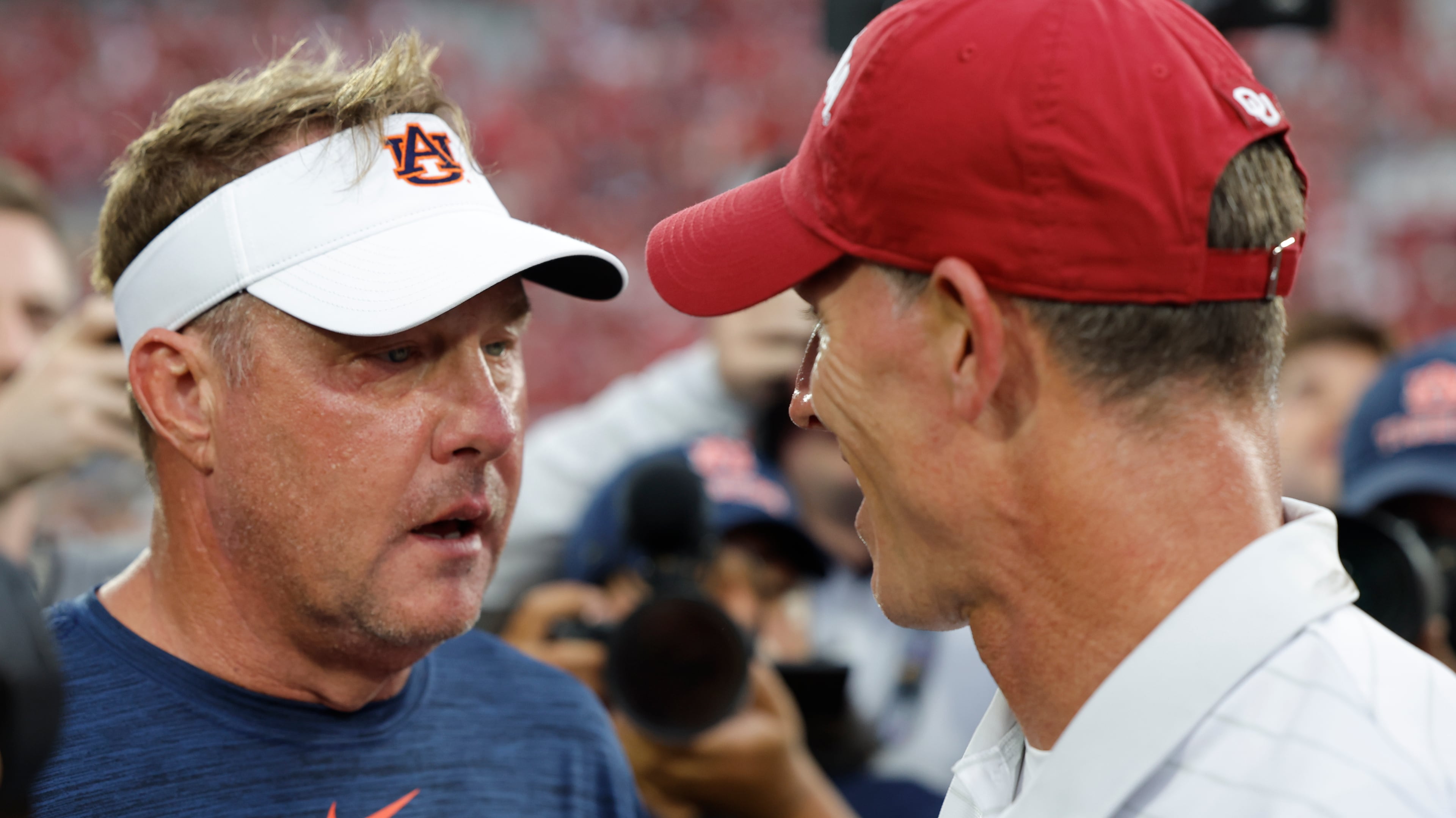 Auburn head coach Hugh Freeze and Oklahoma head coach Brent Venables meet mid field after an NCAA college football game Saturday, Sept. 20, 2025, in Norman, Okla. (AP Photo/Alonzo Adams)