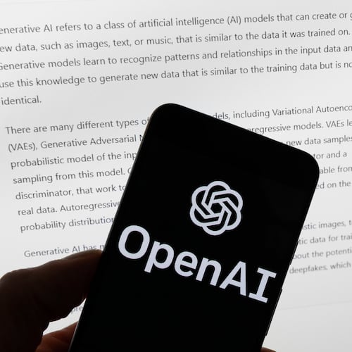 FILE - The OpenAI logo is displayed on a mobile phone in front of a computer screen with output from ChatGPT, March 21, 2023, in Boston. (AP Photo/Michael Dwyer, File)