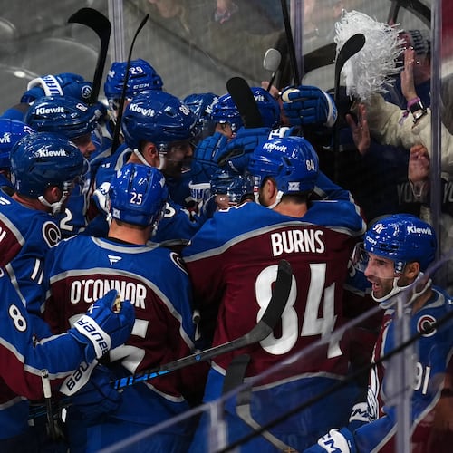 Colorado Avalanche center Nicolas Roy (10) is congratulated by teammates after scoring the game winning goal against the Los Angeles Kings in overtime of Game 2 in the first round of the NHL hockey Stanley Cup playoffs, Tuesday, April 21, 2026, in Denver. (AP Photo/Jack Dempsey)