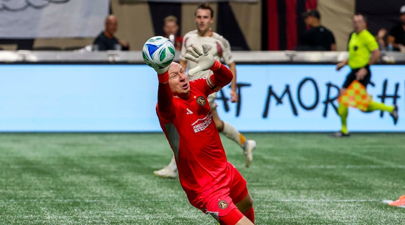 Atlanta United goalkeeper Brad Guzan (1) dives for a save against DC United during the first half of a soccer match in Atlanta, Saturday, Oct. 18, 2025. (Miguel Martinez/AJC)