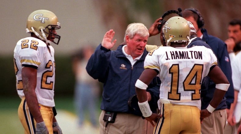 Georgia Tech coach George O'Leary talks with quarterback Joe Hamilton and wide receiver Dez White in the third quarter of the game between Georgia Tech and North Carolina at Bobby Dodd Stadium on Saturday, October 9, 1999. (LEVETTE BAGWELL/AJC File)