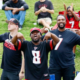 Fans celebrate during the Atlanta Falcons’ joint practice with the Tennessee Titans at the Falcons Practice Facility on Tuesday, Aug. 12, 2025, in Flowery Branch. (Miguel Martinez/AJC)
