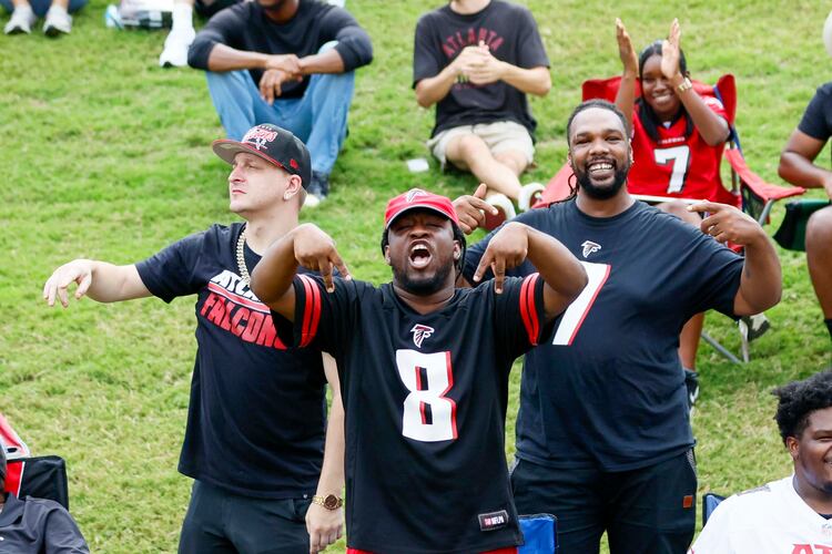 Fans celebrate during the Atlanta Falcons’ joint practice with the Tennessee Titans at the Falcons Practice Facility on Tuesday, Aug. 12, 2025, in Flowery Branch. (Miguel Martinez/AJC)