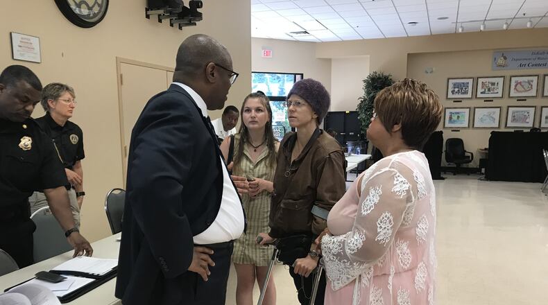Zach Williams (far left), DeKalb County’s chief operating officer, speaks to advocates who complained about conditions at the jail during a county commission meeting on April 23, 2019. TIA MITCHELL/TIA.MITCHELL@AJC.COM