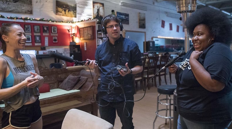 Host Kalena Boller (right) and producer Sean Powers (center) interview Elizabeth Davidovich at Southeast Movie and Stunt House (S.M.A.S.H.) in Atlanta’s Adair Park neighborhood Sept. 13 for the podcast “The Credits.” Though the podcast has been around for about a year, it now has come under the umbrella of Georgia Public Broadcasting. ALYSSA POINTER / ALYSSA.POINTER@AJC.COM