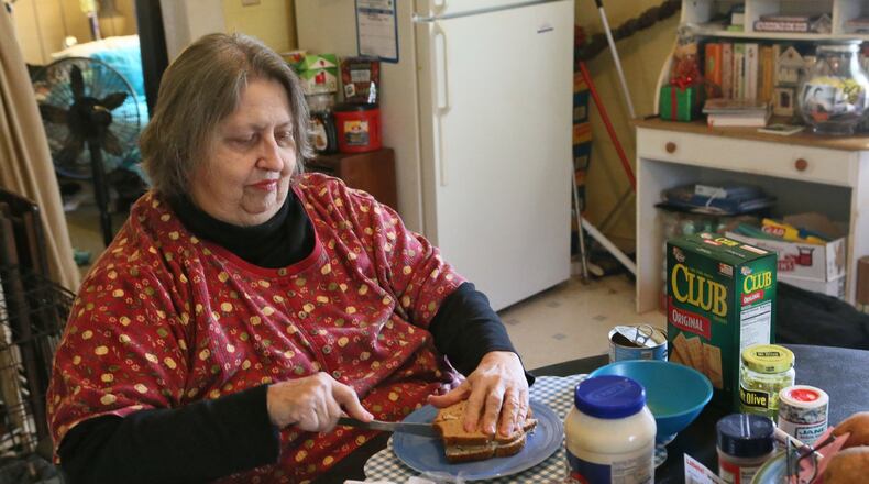 Jo Ann de la Moriniere, 73, who says she has had a lot of trouble with her food stamps, prepares lunch at her home in Ball Ground. Georgia’s problem-wracked food stamp system continues to block people from getting the assistance. Much of the problem focuses on the flawed call-in center, which people use to apply and ask questions and undergo interviews. In January, nearly half of the callers could not get through. Wait times stretch over hours. The agency has a 40,000 case backlog.