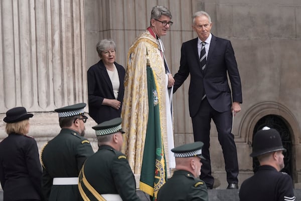 Former prime ministers Tony Blair, right, and Theresa May, left, depart following a special service at St Paul's Cathedral to mark the anniversary of the terrorist attacks in London July 7, 2005 that killed 52 people, in London, Monday July 7, 2025. (Stefan Rousseau/PA via AP)