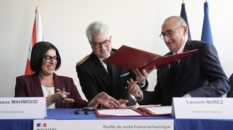 Britain's Home Secretary Shabana Mahmood, left, signs an agreement with France's Interior Minister Laurent Nunez during her visit in Dunkirk, France, Thursday April 23, 2026. (Stefan Rousseau/Pool Photo via AP)