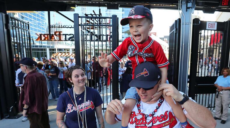 March 31, 2017, Atlanta: Excited Braves fans David Swinehamer, his son Austin, 4, and wife Amber enter the gates for the first time for the MLB exhibition game against the N.Y. Yankees for the soft opening of SunTrust Park on Friday, March 31, 2017, in Atlanta. Curtis Compton/ccompton@ajc.com